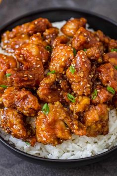 a black bowl filled with chicken and rice