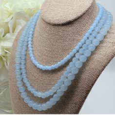 Indulge in the timeless elegance of the Amicae Blue Single Strand Necklace - a handcrafted crystal glass masterpiece that exudes sophistication with every single strand - The icy blue hue of the beads brings images of clear winter skies. In contrast, the single-strand design adds a touch of simplicity to this work. Whether you're attending your best friend's wedding or dressing for an important business meeting, the Amicae Blue Necklace will surely be your go-to accessory for that perfect finish Elegant Light Blue Single Strand Beaded Necklace, Light Blue Polished Beads Necklace For Gift, Elegant Blue Necklace With Round Beads, Elegant Light Blue Crystal Necklace For Gift, Elegant Light Blue Crystal Necklace Gift, Light Blue Single Strand Necklace With Round Beads, Light Blue Round Beads Necklace For Gifts, Blue Necklaces With 8mm Beads For Jewelry Making, Light Blue Faceted Beads Elegant Jewelry