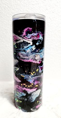 a black and purple glass with some designs on it