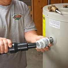 a man is working on a water heater