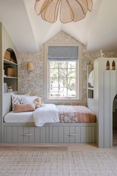 a room with a bed, bookcases and a window in the ceiling area