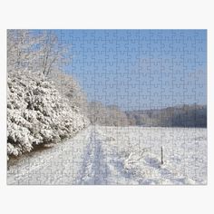 a jigsaw puzzle is shown in the middle of a snowy field with trees