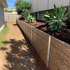 a long wooden fence next to a house