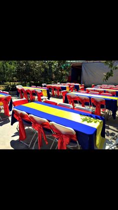 tables and chairs are set up with red, white, and blue tablecloths