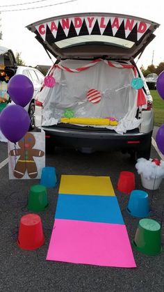 the trunk of a car is decorated with balloons and streamers