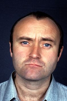 a close up of a person wearing a tie and looking at the camera with an intense look on his face