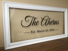 a white framed sign that says the queens est, march 29, 2009 in black lettering