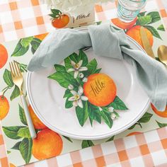 an orange themed place setting on a checkered table cloth