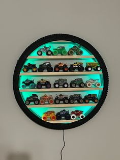 a clock that has some cars on the inside of it and is lit up with green light