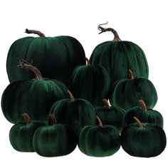 a pile of green velvet pumpkins sitting next to each other on a white background