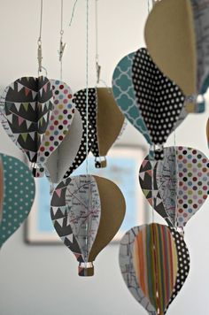 several paper hot air balloons hanging from strings