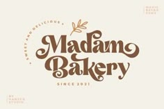 the madan bakery logo is shown in brown and white colors, with an orange flower on