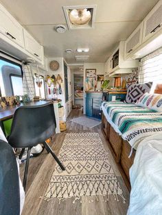 the inside of an rv with a bed and desk