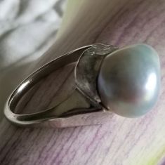 "* This beautiful pearl ring would be a wonderful gift to a bride on her wedding day, or perhaps the mother of the bride or groom! The silvery gray pearl is is unique and beautful, giving this ring tons of understated charm and elegance. This ring is very sturdy and well-made, and it shows! * This piece weighs 6.7 grams, and is stamped \"14K\" inside the shank. The pearls measure approximately 12.6 mm x 12.9 mm This ring is a US size 7. Please message us about sizing options prior to purchase! * Silver Pearl Ring With Polished Finish For Wedding, Unique Polished Pearl Ring For Wedding, Modern Silver Pearl Wedding Ring, Silver High Luster Pearl Ring For Anniversary, Silver Pearl Ring With High Luster For Gift, Unique Wedding Pearl Ring With Polished Finish, Formal Silver Pearl Ring With High Luster, Silver High Luster Pearl Ring For Gift, Formal High Luster Silver Pearl Ring