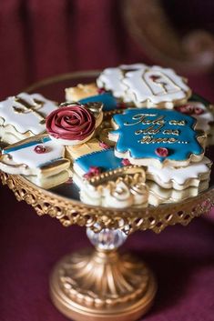 decorated cookies are on a gold pedestal