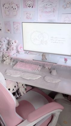 a white desk topped with a computer and lots of stuffed animals