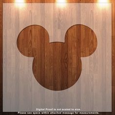 a wooden floor with a mickey mouse cut out on it's side and some lights around the perimeter