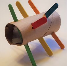 an object made out of toilet paper and popsicle sticks