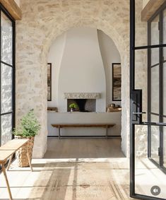 the interior of a house with stone walls and arched doorways