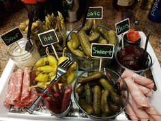 a table topped with bowls filled with different types of pickles and other food items