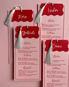 three red and white menu cards with tassels