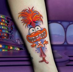 a cartoon character tattoo on the leg