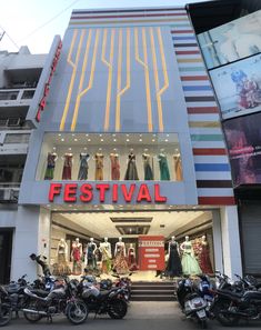 motorcycles parked in front of a building with the word festival on it's side