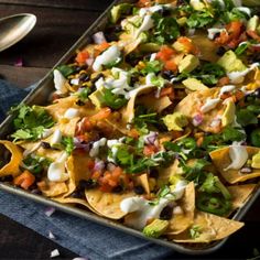 a tray filled with nachos and tortilla chips