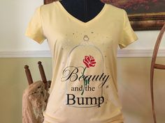 a t - shirt with the words beauty and the bump on it