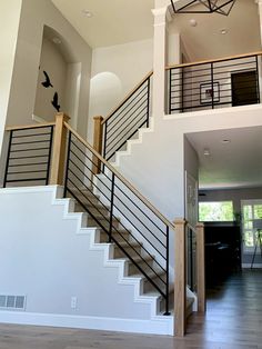 an open floor plan with stairs and railings