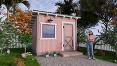 a woman standing in front of a small pink shed with flowers and trees around it