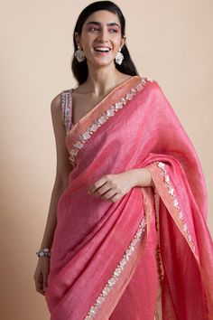 Editor's Note Featuring a pink hand-embroidered linen silk saree. This comes with matching unstitched linen silk blouse piece. Color: Pink Fabric: Linen Silk Length: Saree Length: 5.5m; Blouse Fabric: 1m Care: Dry Clean Only About the Designer Saksham & Neharicka make modernizing Indian wear with rich handwoven textiles, fresh intricate textures, chic and classic silhouettes, Saksham & Neharicka handcraft all designs to eternal perfection. Their soulful stories are inspired by nature, mythology, Pink Blouse Saree, Drape Lehenga, Pink Saree Blouse, Saree Chiffon, Linen Silk Saree, Off White Saree, Indian Block Print Fabric, Sari Design, Saree For Women