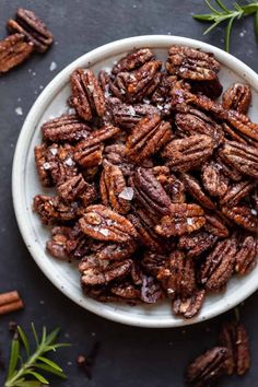 a white bowl filled with pecans and the words holiday spiced pecans on top