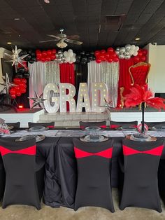 the table is set up with black and red decorations