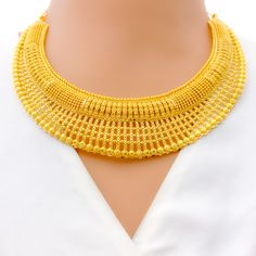 This 22k gold necklace set features a brilliant bright striped design, perfect for adding elegance to any outfit. Weighing 63.7 grams, it showcases a yellow gold finish that enhances its striking striped pattern. The set has a length of 18 inches with adjustable 1.5-inch links for a comfortable fit. Secured with a hook lock, it combines style and practicality. The matching earrings, each 2.25 inches long, feature screw back posts for added security. Ideal for those who appreciate luxurious and sophisticated jewelry, this set brings a touch of opulence and radiant charm to your collection. PRODUCT DETAILS Gold Purity(karat): 22k Gold Weight(grams): 63.7 Item Finish: Yellow Gold Set Length: 18" Adjustable Links: 1.5" Links Lock Style: Hook Lock Matching Earrings: Included Earring Length: 2.2 22k Gold Necklace Set, 22k Gold Necklace, Pure Gold Jewellery, Bridal Jewelry Necklace, Precious Stones Rings, Sophisticated Jewelry, Diamond Pendant Sets, Fancy Necklace, Jhumki Earrings