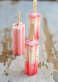 three popsicles with toothpicks sticking out of them