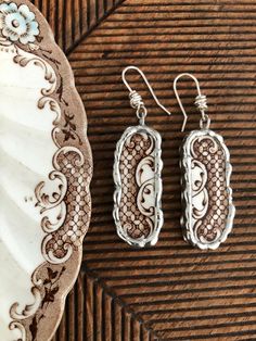 These pretty brown and white dangle earrings are made from a antique English transferware plate that I found in my antiquing travels while in Central NY. Each piece is hand cut on a wet saw, hand ground on a grinding wheel and soldered with lead free silver solder. They have been polished to a gleaming silver. You can keep them looking like new by polishing them using a silver polishing cloth. Earrings measure 2 1/2" from the top of the earring wire. I made the earring wires from sterling silver Cloth Earrings, China Earrings, Transferware Plate, Broken China Jewelry, Earring Wire, Earring Wires, China Jewelry, Broken China, Gift For Her Birthday