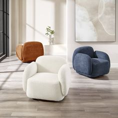 three different colored chairs in a room with wood flooring and white walls on either side