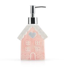 a soap dispenser with a pink house design on the front and white background