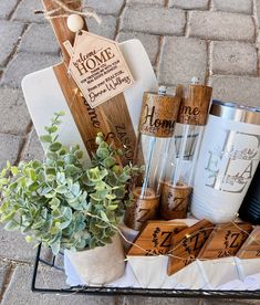 a basket filled with lots of different items on top of a brick floor next to a potted plant