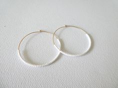 These hoops are gold filled and they have dainty and high quality white seed beads. Also available with sterling silver, 14kt gold and 14kt rose gold (choose preference at checkout). ❤ SIZES They measure 45 mm in diameter. ❤ PROCESSING AND SHIPPING Most orders are made and shipped out in one business day. Please check delivery timeframes for your location on the description below. ❤ CUSTOM ORDERS Contact me to discuss you needs! Go back to my shop: https://www.etsy.com/shop/StephanieMartinCo See White 14k Gold Filled Hoop Earrings, White 14k Gold Filled Hoop Jewelry, Handmade White 14k Gold Filled Hoop Earrings, Handmade 14k Gold Filled White Hoop Earrings, White Round Earrings With Gold Beads, Minimalist White Hoop Earrings For Everyday, White Gold Beaded Round Earrings, White Minimalist Round Hoop Earrings, Minimalist White Round Hoop Earrings