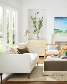 a living room filled with furniture and a painting on the wall above it's fireplace