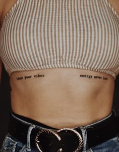 a woman's stomach with the words trust your wishes written on her left side