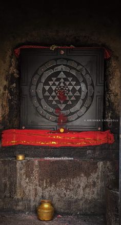 an altar with a red cloth on it and a gold bowl in front of it