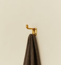 a towel hanging on the wall next to a hook