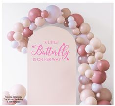 a little butterfly is on her way sign surrounded by pink and white balloons in the shape of a arch