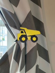 a curtain with a yellow construction truck on it