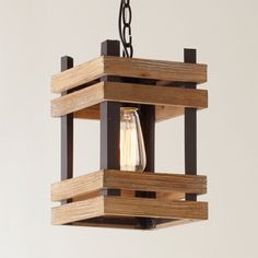 a wooden light fixture hanging from a ceiling