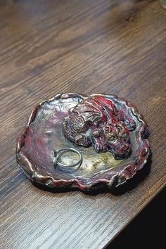 a ring dish sitting on top of a wooden table