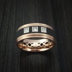 This 14K Rose Gold band features: - 8mm Width- Stepped Bevel Ring Shape- Satin Finish- Patterned Carbon Fiber Inlay-Three Bezel Set .05ct Princess Cut DiamondsThis ring is offered through our website and is part of the MARDINI Series of Innovative Metal rings manufactured by Malo Bands. All of Malo's rings will also include either a "Malo Bands" or "Mardini" Logo, which we cannot remove by request. This ring also has the "Mardini" name plate visible on the exterior of the ring opposite the diamo Luxury Bands With Diamond Accents, Luxury Bands For Anniversary, Luxury Bands With Diamond Accents For Formal Events, Formal Rose Gold Rings With Channel Set, Luxury Rose Gold Bands For Formal Occasions, Luxury Formal Rose Gold Bands, Luxury Rose Gold Channel Set Jewelry, Luxury Rose Gold Jewelry With Channel Set, Luxury Rose Gold Wedding Bands